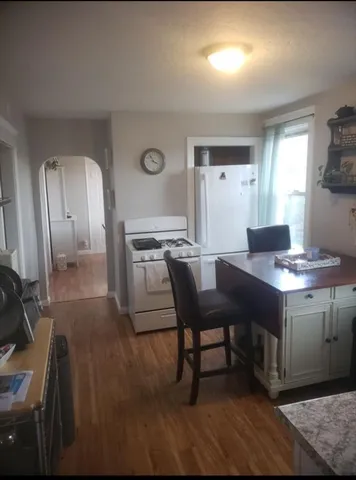 a kitchen with a table chairs and a refrigerator