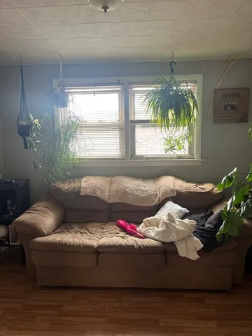a living room with furniture and a chandelier