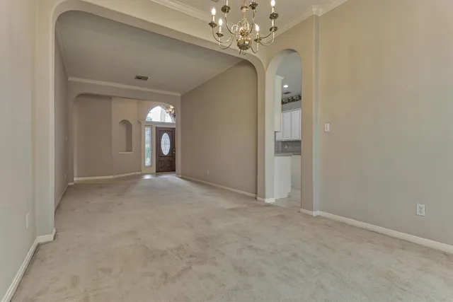 a view of a chandelier in big room and chandelier