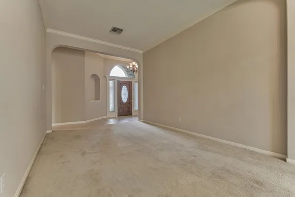 a living room with wooden floor and a fireplace