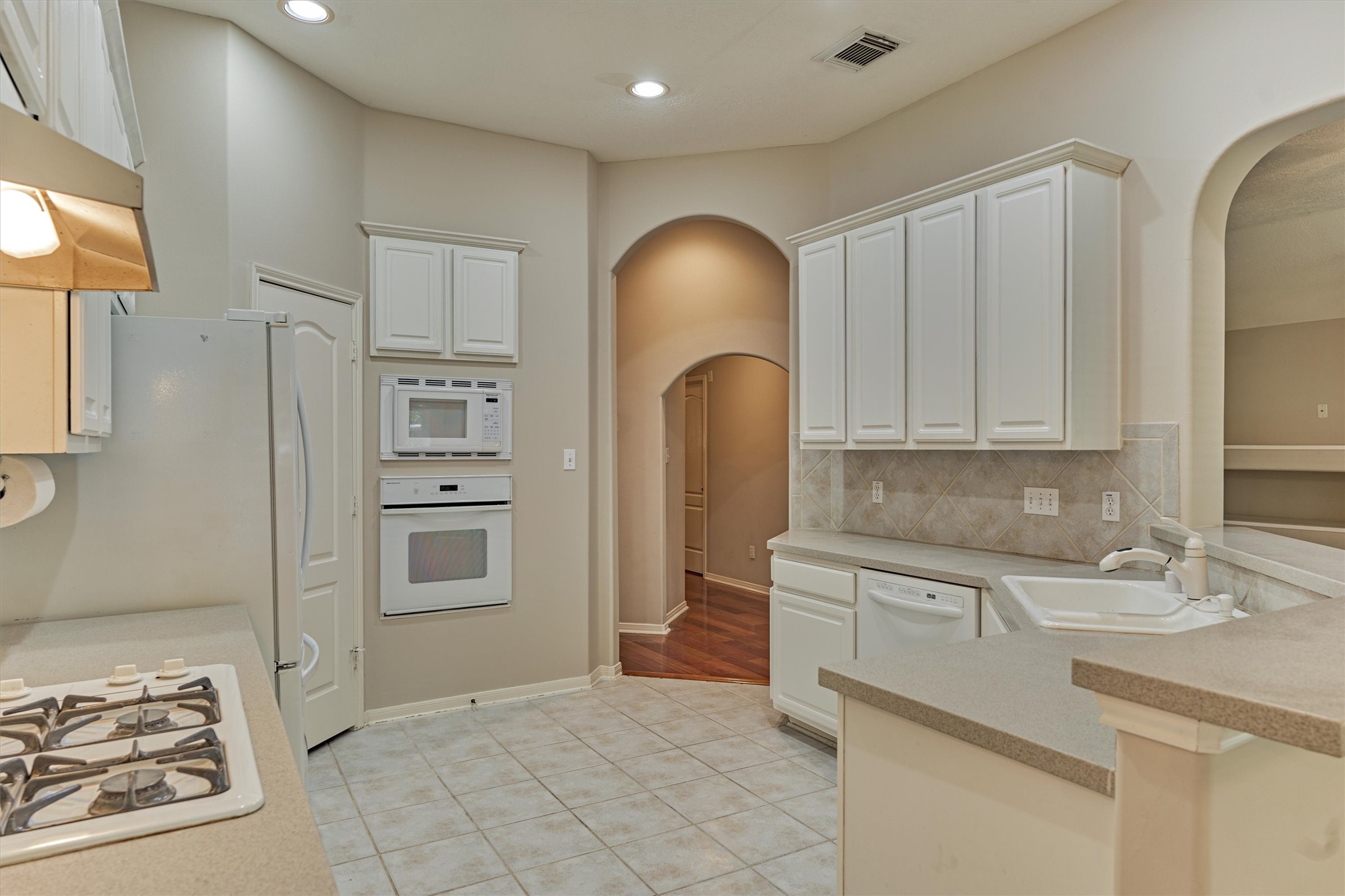 930 Arbor Pine Tomball, TX 77375 - Photo 22 of 45 a kitchen with stainless steel appliances granite countertop a refrigerator and a sink