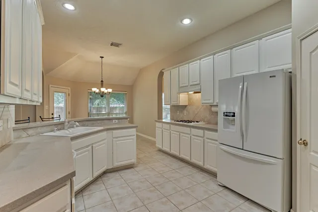 a kitchen with stainless steel appliances a sink stove and cabinets