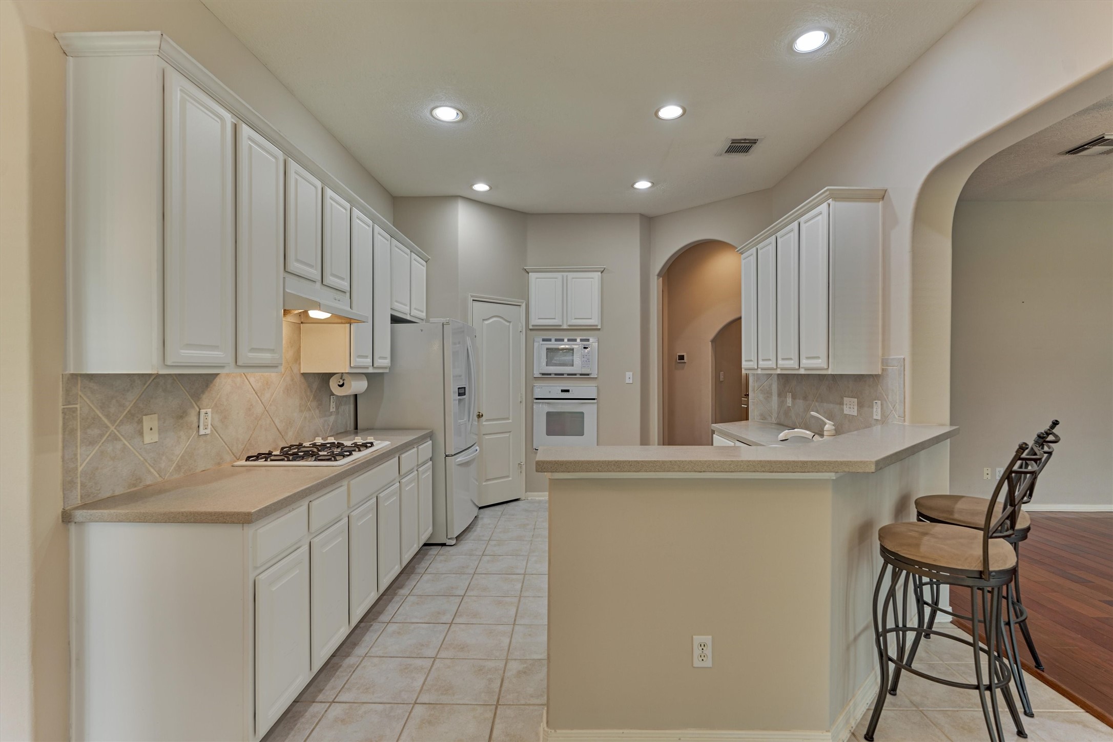 930 Arbor Pine Tomball, TX 77375 - Photo 3 of 45 a kitchen with stainless steel appliances granite countertop a sink and cabinets