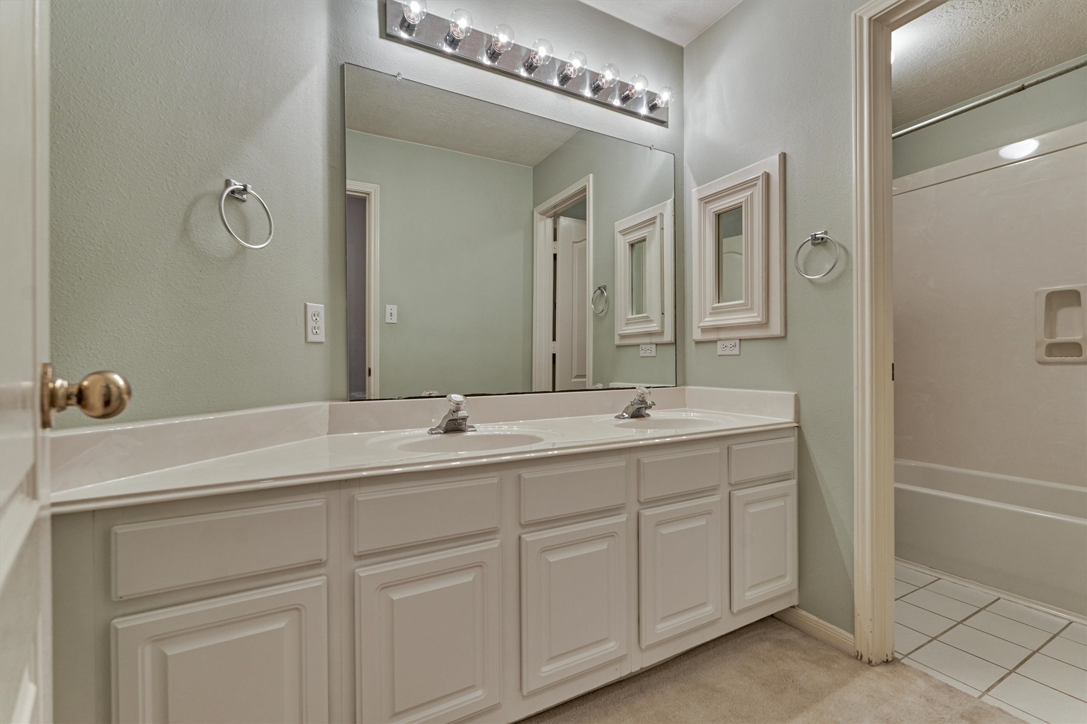 930 Arbor Pine Tomball, TX 77375 - Photo 34 of 45 a bathroom with a double vanity sink a mirror and a bathtub