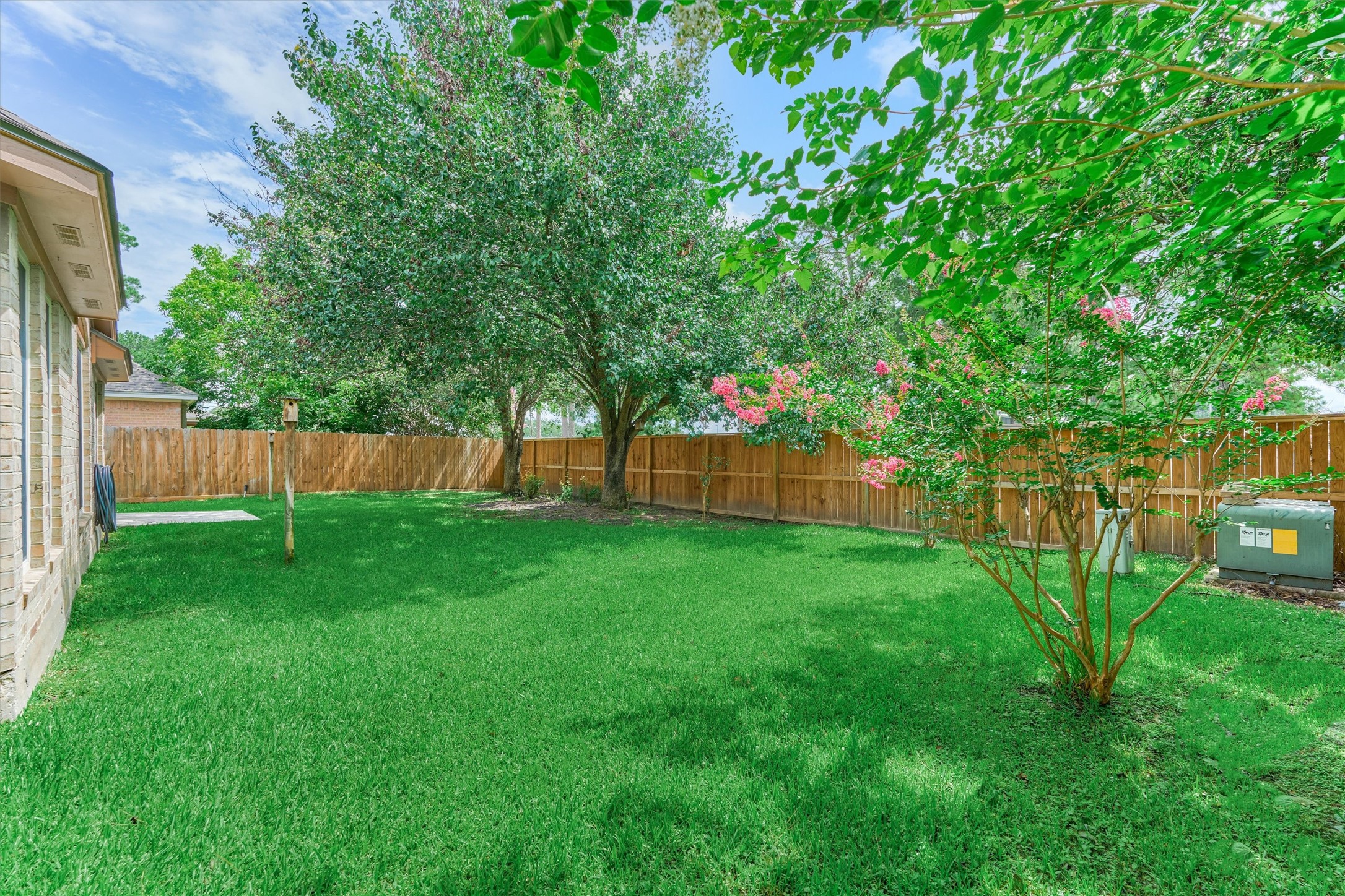 930 Arbor Pine Tomball, TX 77375 - Photo 43 of 45 a view of a backyard with a trees and wooden fence