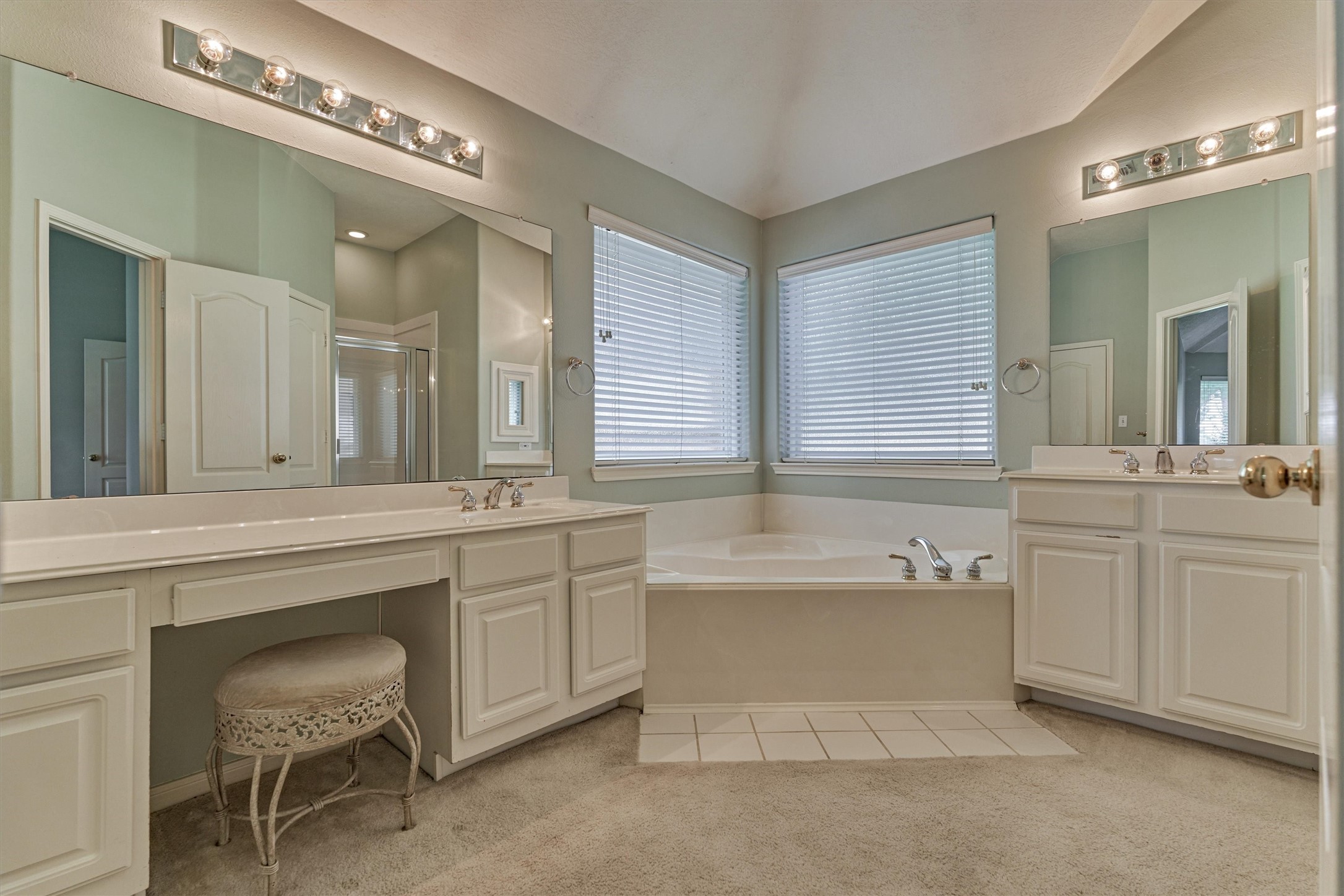 930 Arbor Pine Tomball, TX 77375 - Photo 5 of 45 a bathroom with a tub a double vanity sink a window and a mirror