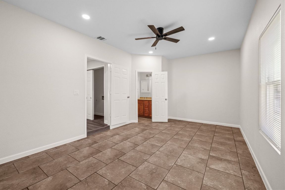 1308 South 45th Street Temple, TX 76504 - Photo 13 of 26 Unfurnished bedroom with recessed lighting, ceiling fan, tile patterned flooring, and connected bathroom
