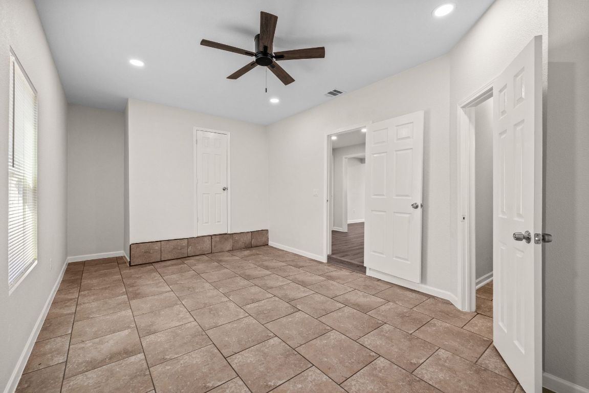 1308 South 45th Street Temple, TX 76504 - Photo 14 of 26 Unfurnished bedroom with a ceiling fan, recessed lighting, and light tile patterned flooring