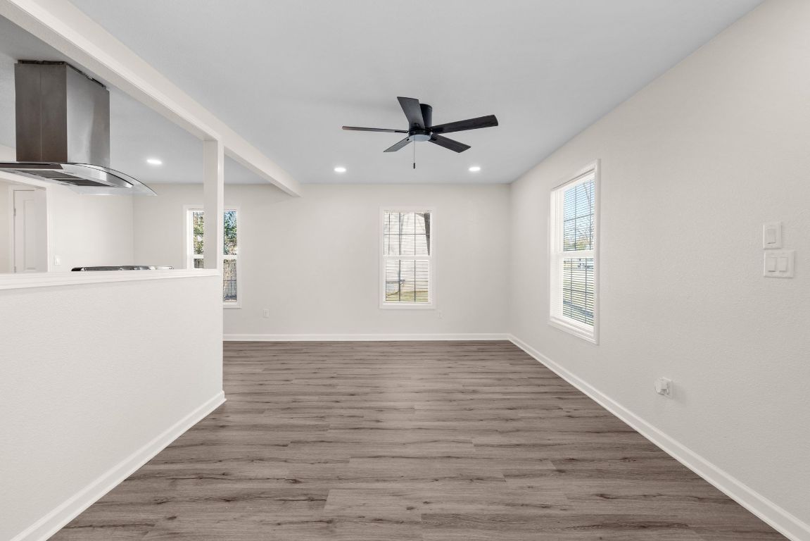 1308 South 45th Street Temple, TX 76504 - Photo 3 of 26 Unfurnished living room with wood finished floors, recessed lighting, and ceiling fan