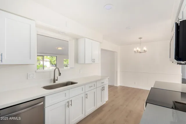 a kitchen with sink cabinets and window