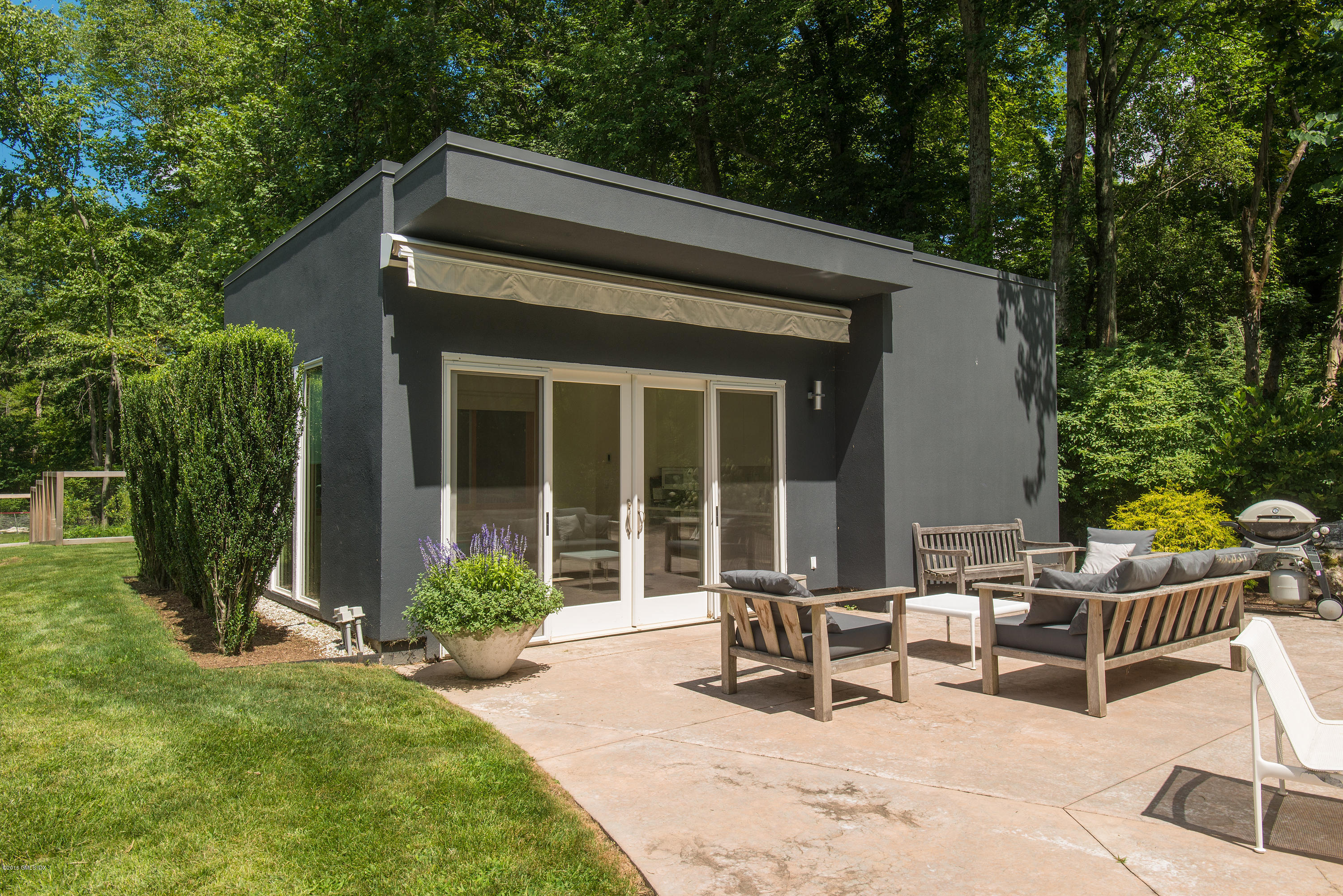 59 Dingletown Road Greenwich, CT 06830 - Photo 17 of 28 a backyard of a house with yard table and chairs