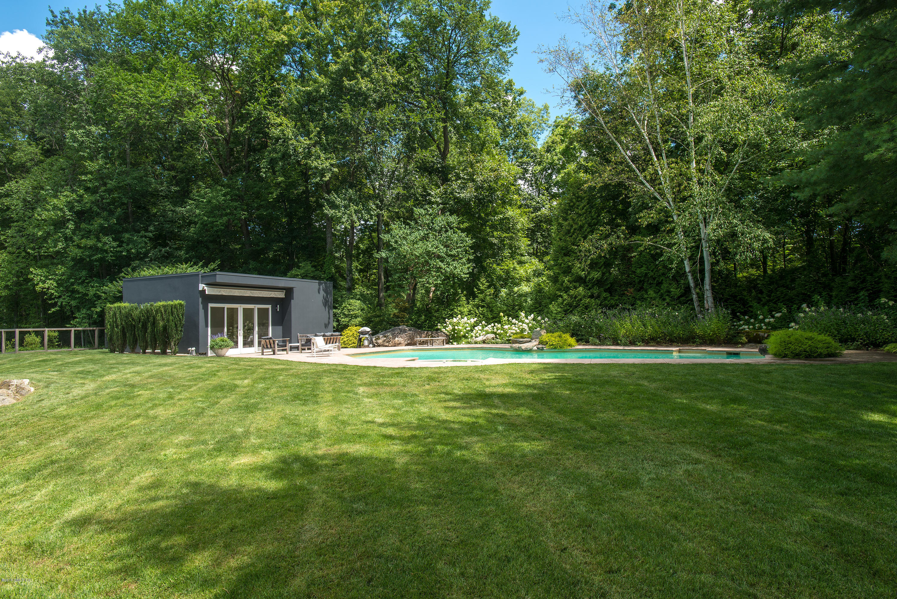 59 Dingletown Road Greenwich, CT 06830 - Photo 28 of 28 a front view of a house with a yard