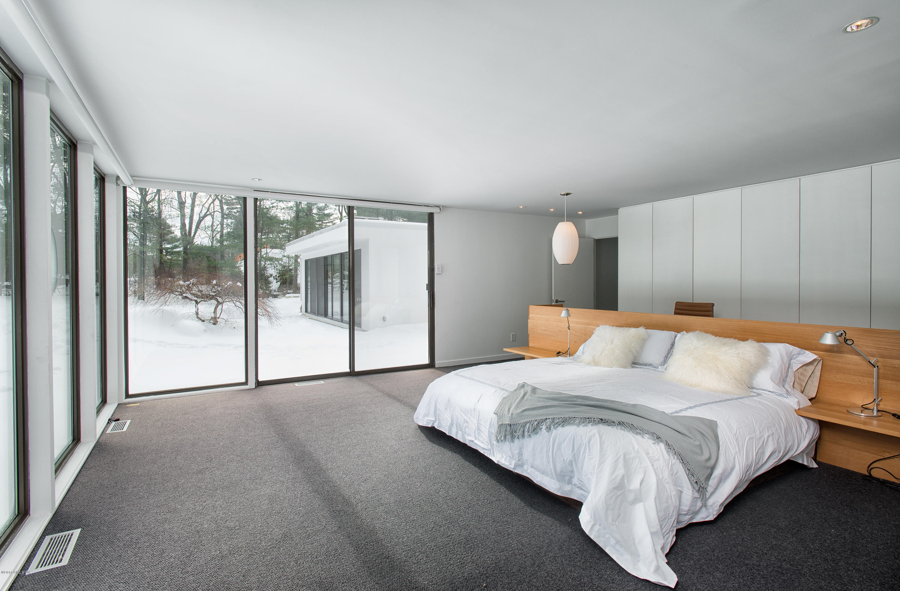 59 Dingletown Road Greenwich, CT 06830 - Photo 10 of 28 a bed room with a bed and a large window