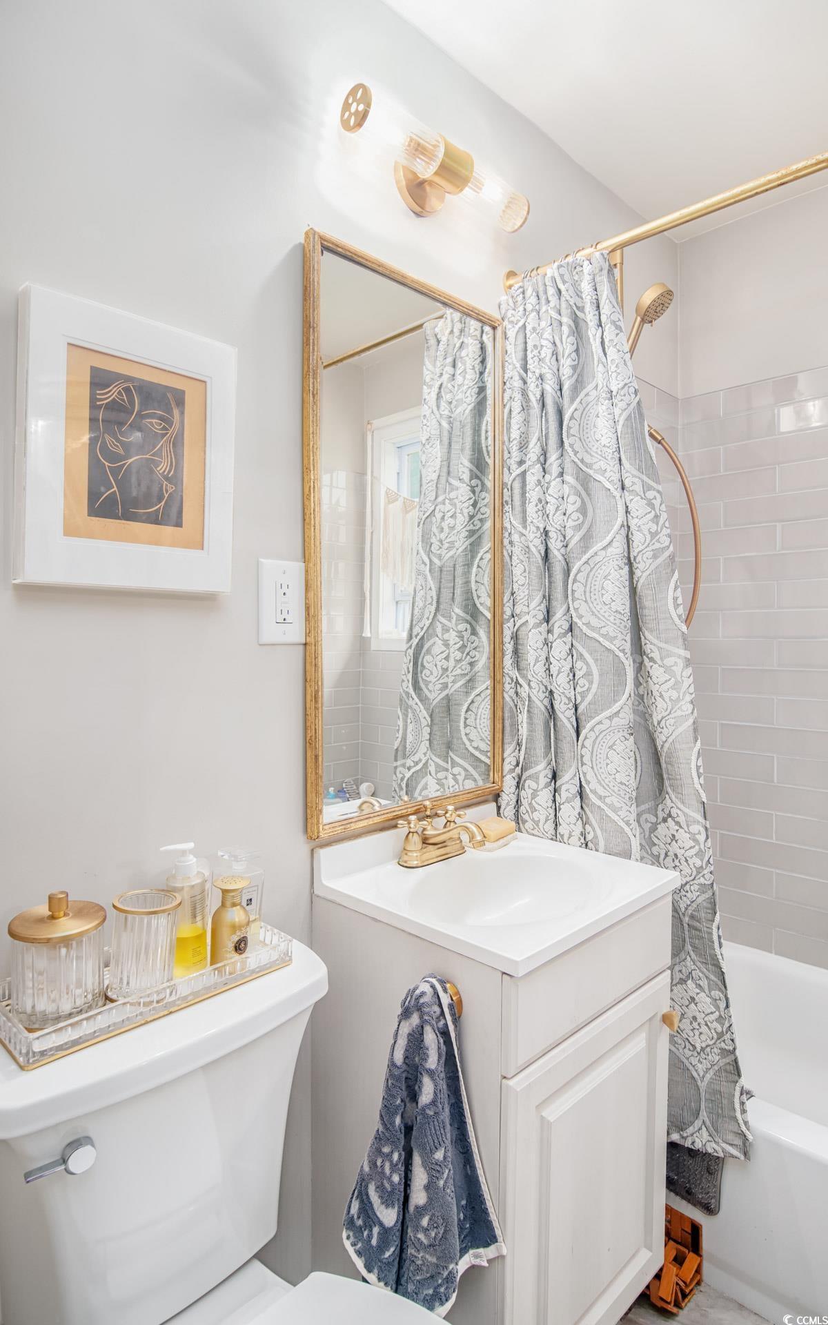 640 Willow Bank Road Georgetown, SC 29440 - Photo 11 of 18 Bathroom featuring toilet, shower / tub combo with curtain, and a sink