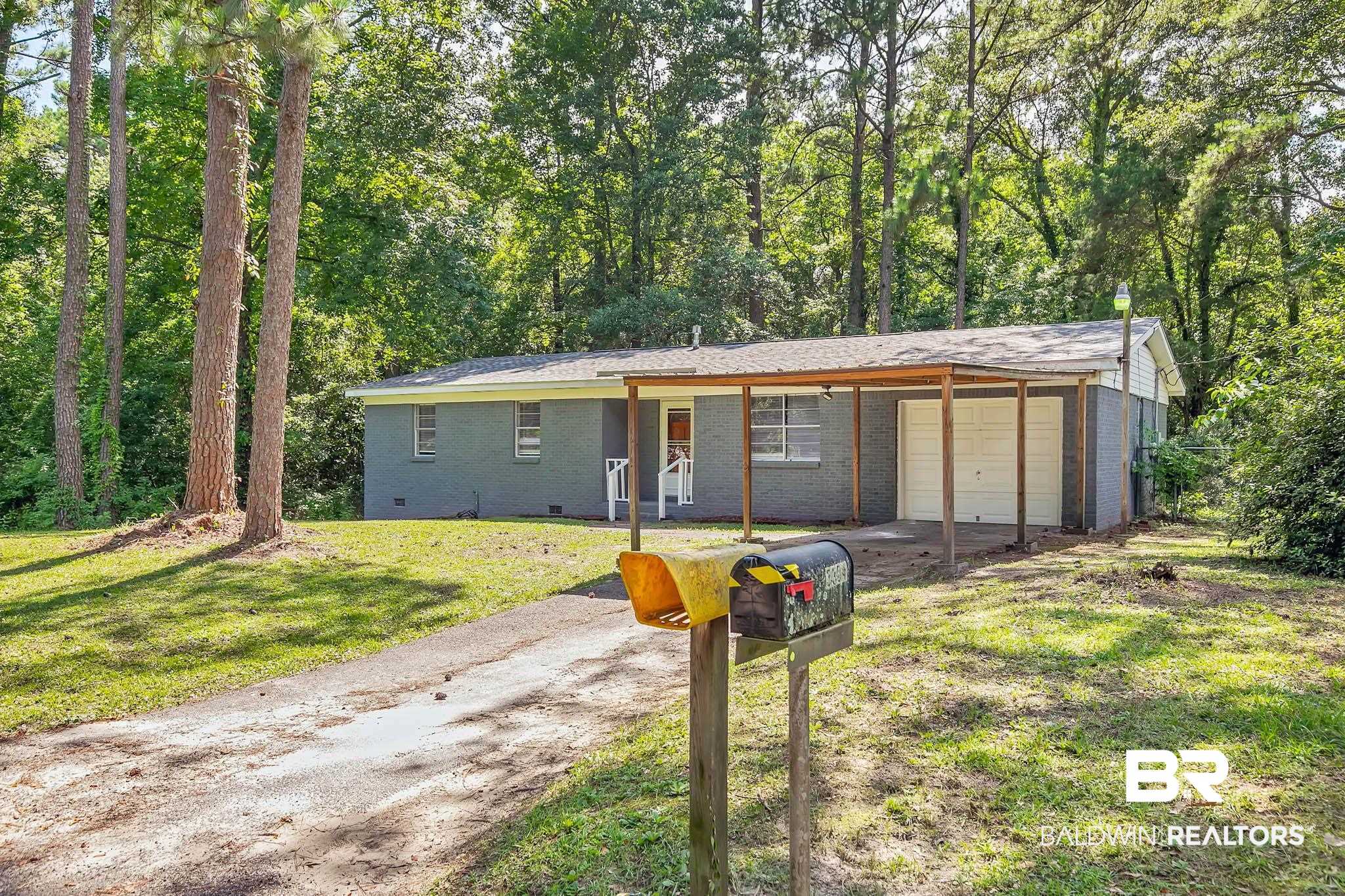 3304 Armond Drive Mobile, AL 36605 - Photo 4 of 62 Ranch-style house featuring driveway, an attached garage, a front yard, and brick siding