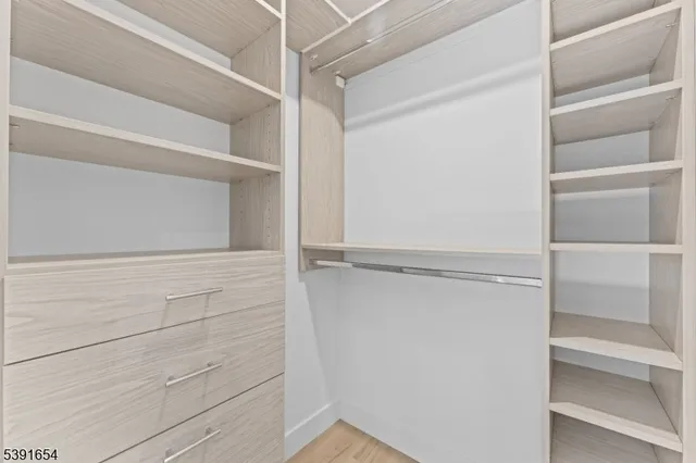 a bedroom with a bed a couch and dresser