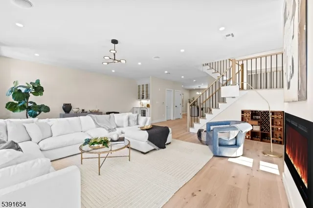 a living room with furniture and a chandelier