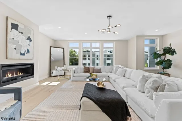 a living room with furniture fireplace and a large window