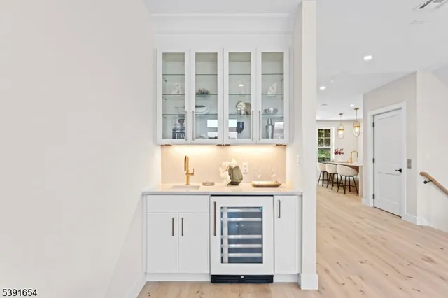 a view of kitchen with wooden floor and cabinets