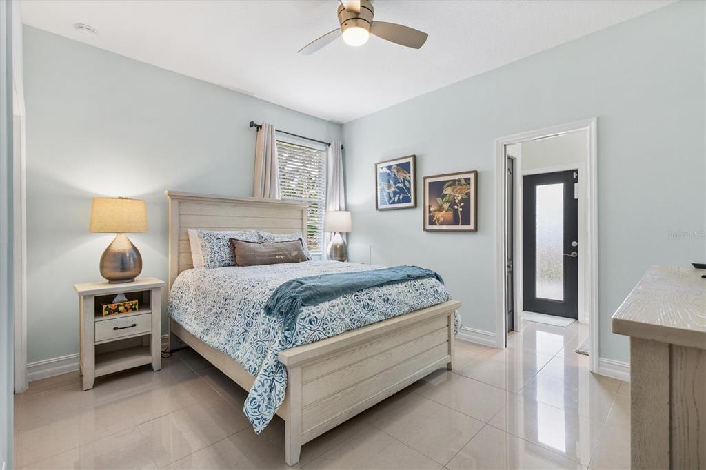 12114 Eagle Point Court Leesburg, FL 34788 - Photo 18 of 39 a bedroom with a bed and a chandelier