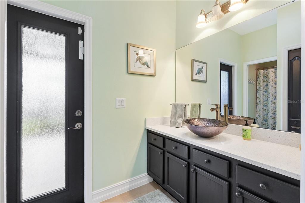 12114 Eagle Point Court Leesburg, FL 34788 - Photo 19 of 39 a bathroom with a granite countertop sink and a mirror