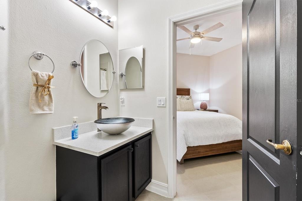 12114 Eagle Point Court Leesburg, FL 34788 - Photo 21 of 39 a en suite bathroom with a sink and a mirror