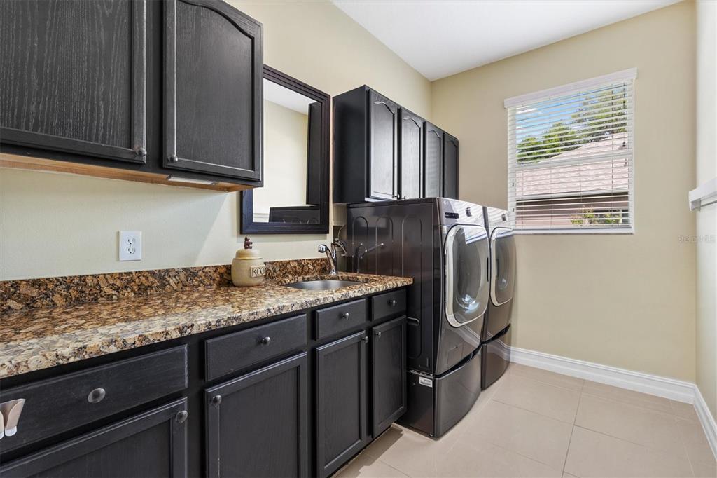 12114 Eagle Point Court Leesburg, FL 34788 - Photo 22 of 39 a kitchen with stainless steel appliances granite countertop a refrigerator and a sink