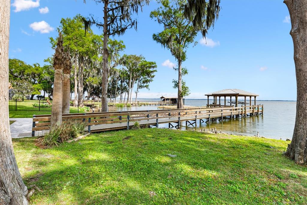 12114 Eagle Point Court Leesburg, FL 34788 - Photo 29 of 39 a view of swimming pool with lawn chairs and a big yard