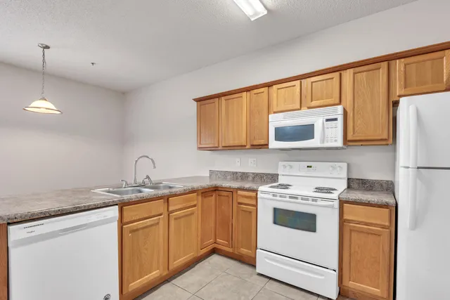 a kitchen with a sink stove and refrigerator
