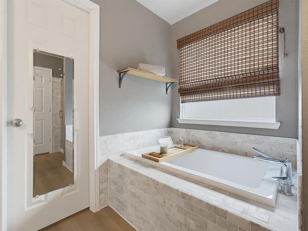 13268 Fencerow Road Fort Worth, TX 76244 - Photo 8 of 25 Soaking tub with mosaic tile surround, chrome fixtures, and a natural woven window shade