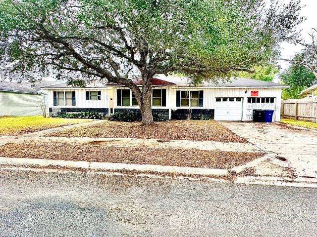 a house that has a tree in front of it