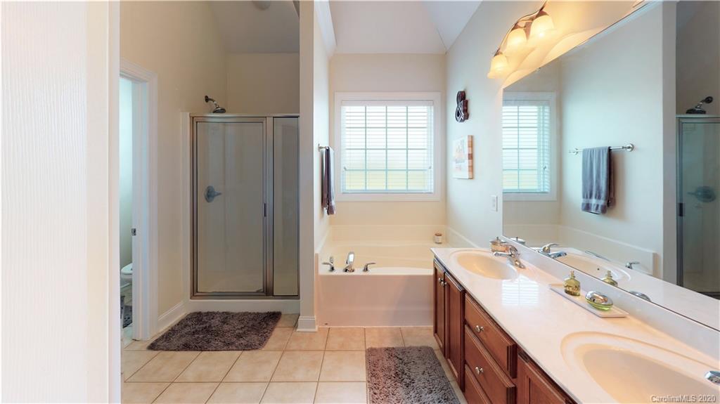 3812 Zebulon Williams Road Monroe, NC 28110 - Photo 12 of 31 a bathroom with a tub sink and a mirror