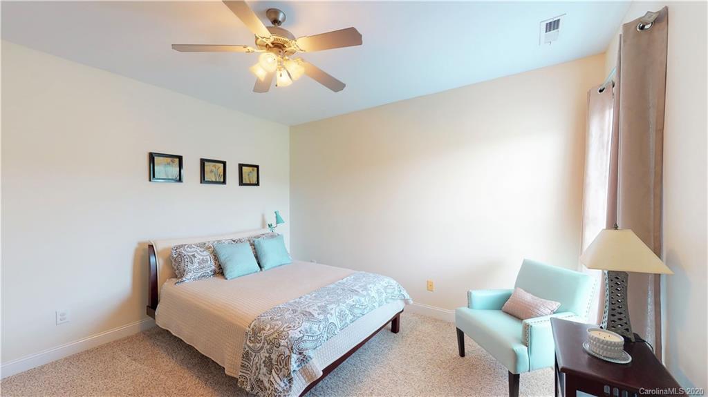 3812 Zebulon Williams Road Monroe, NC 28110 - Photo 17 of 31 a bedroom with a bed and a lamp