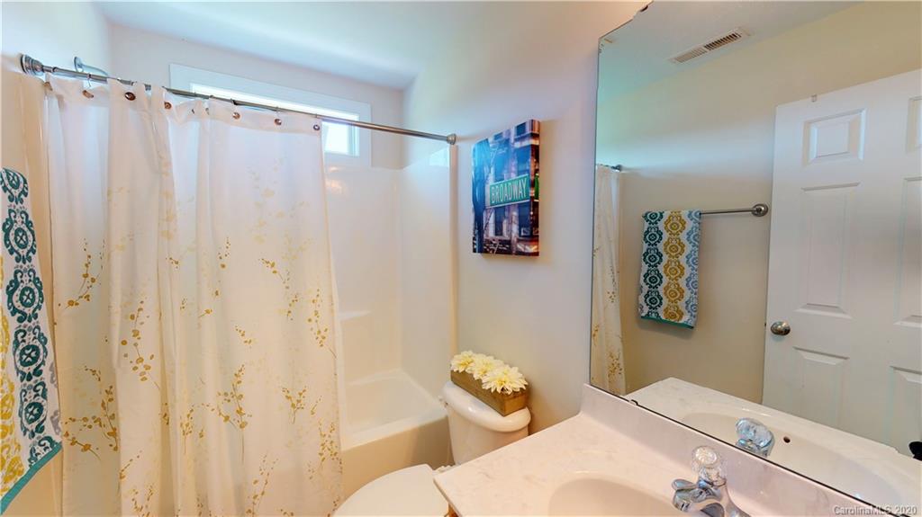 3812 Zebulon Williams Road Monroe, NC 28110 - Photo 22 of 31 a bathroom with a shower curtain and a curtain