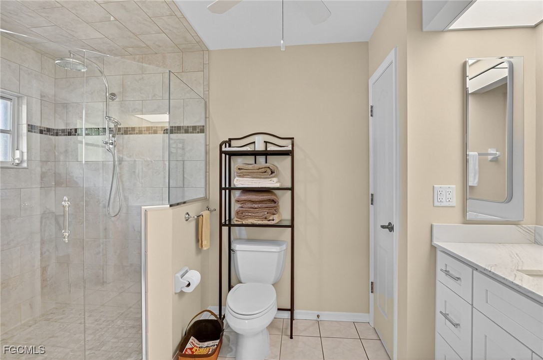 4306 Southwest 3rd Avenue Cape Coral, FL 33914 - Photo 25 of 50 a bathroom with a granite countertop toilet a sink and shower