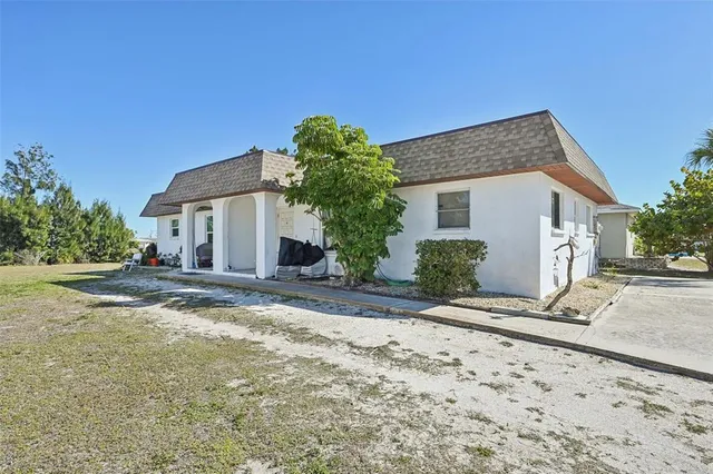a view of a house with a yard and plant