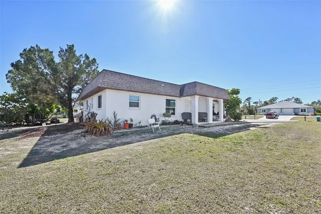 a view of a house with swimming pool and a yard