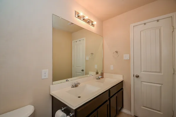 a bathroom with a double vanity sink and mirror