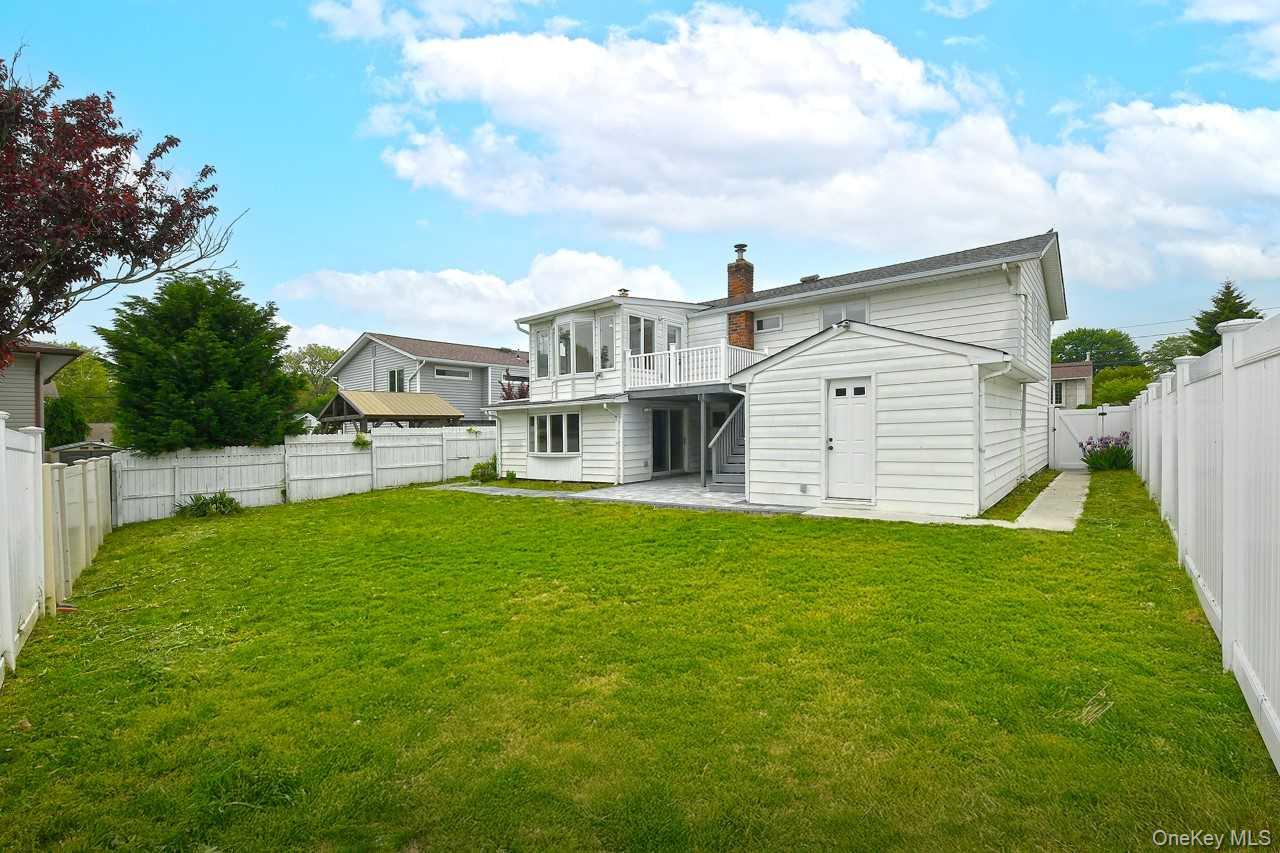 107 Beverly Road Massapequa, NY 11758 - Photo 32 of 41 a view of an house with backyard space and balcony