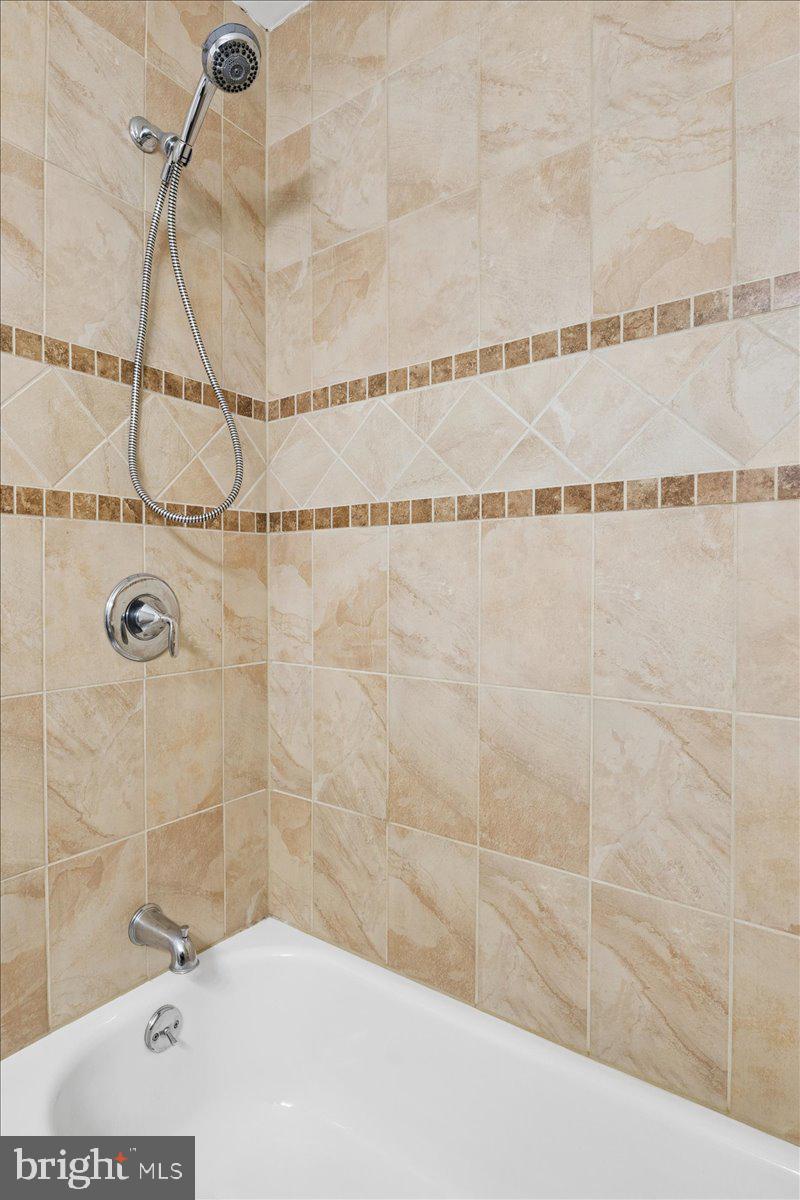 38 Gramercy Lane Willingboro, NJ 08046 - Photo 21 of 23 Elegant tiled shower and tub space.