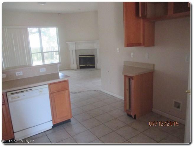 12066 Spring Ridge Drive Jacksonville, FL 32258 - Photo 12 of 18 a kitchen with granite countertop a sink cabinets and a fireplace