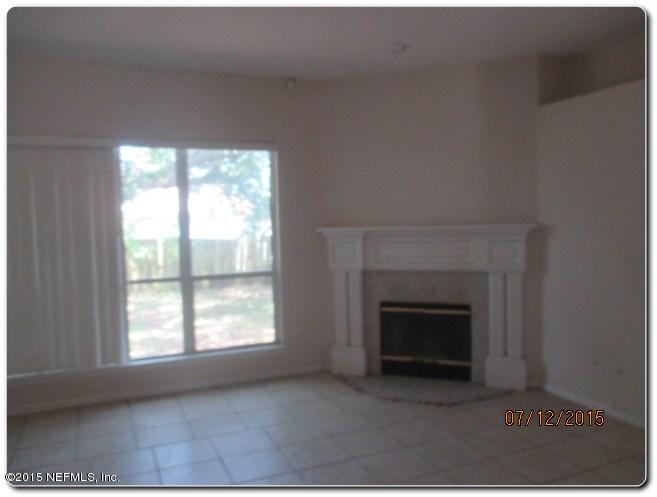 12066 Spring Ridge Drive Jacksonville, FL 32258 - Photo 13 of 18 a view of empty room with a fireplace