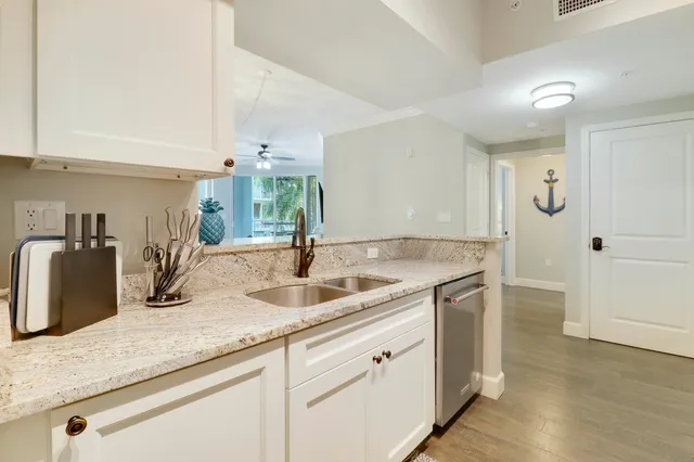 a kitchen with sink and mirror