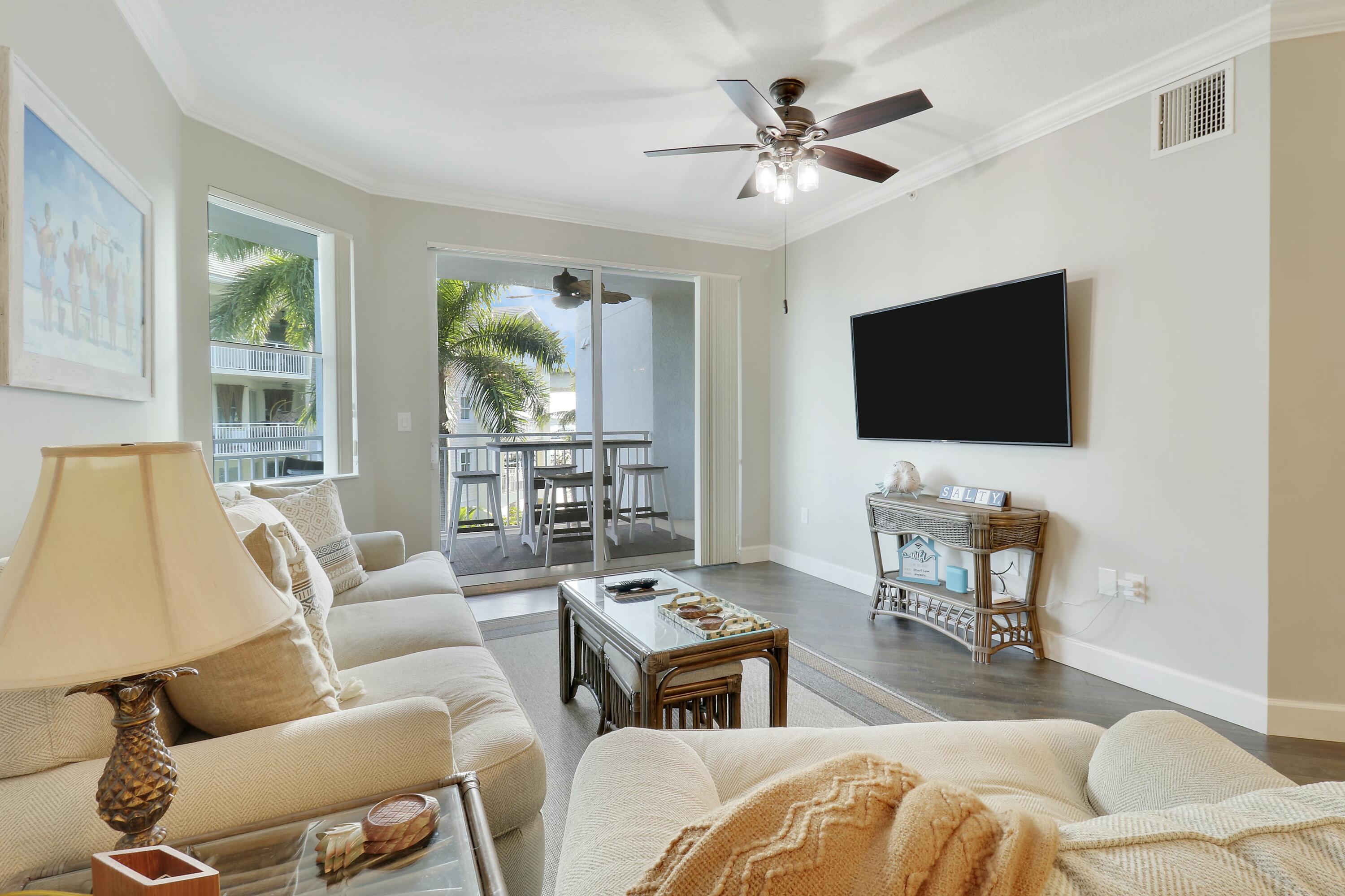 215 Northwest Flagler Avenue, Unit 301 Stuart, FL 34994 - Photo 16 of 34 a living room with furniture and a flat screen tv