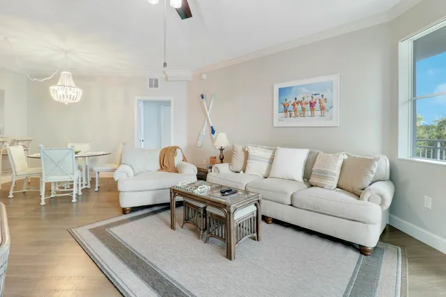 a living room with furniture a rug and a chandelier
