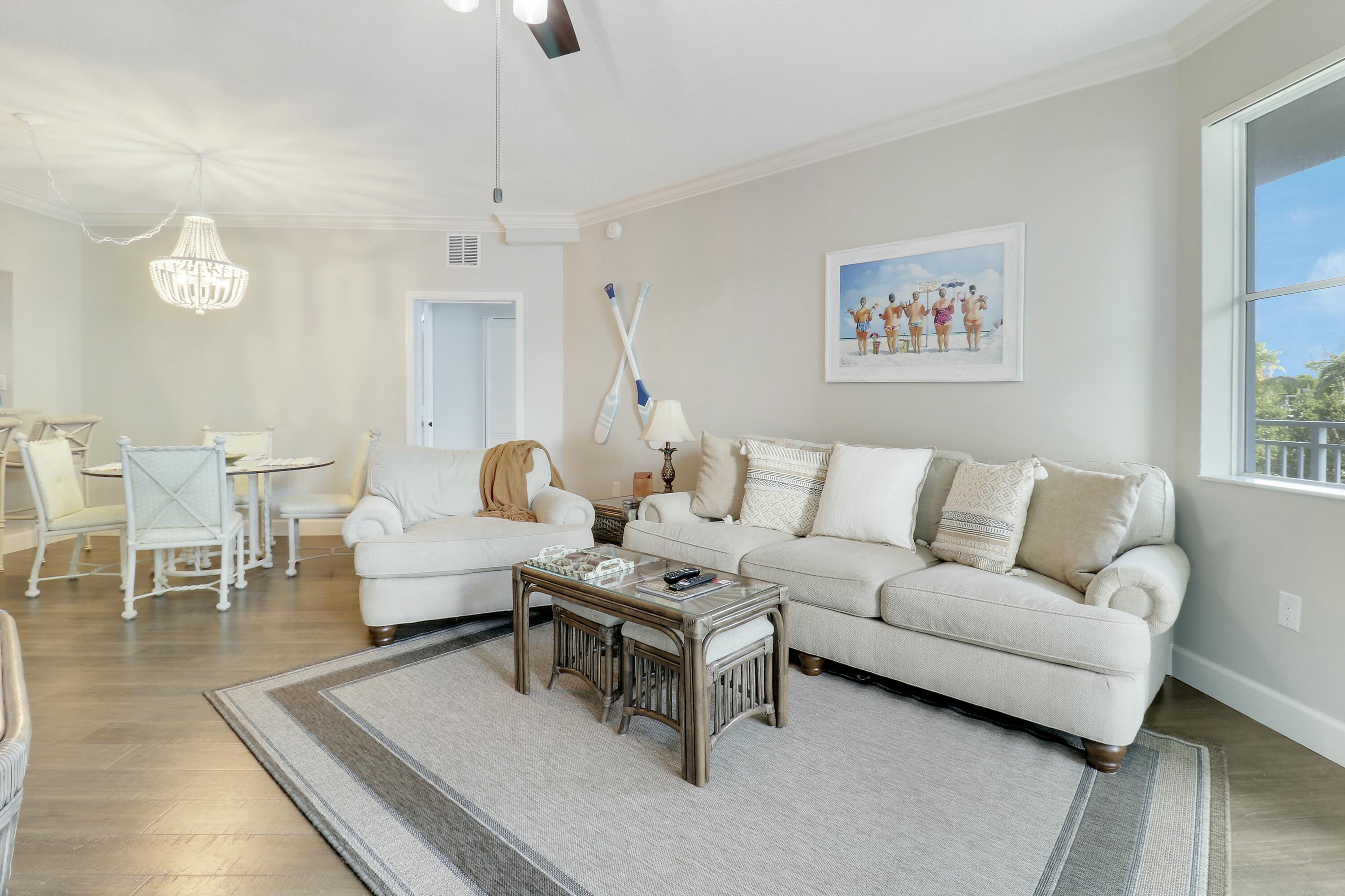 215 Northwest Flagler Avenue, Unit 301 Stuart, FL 34994 - Photo 19 of 34 a living room with furniture a rug and a chandelier