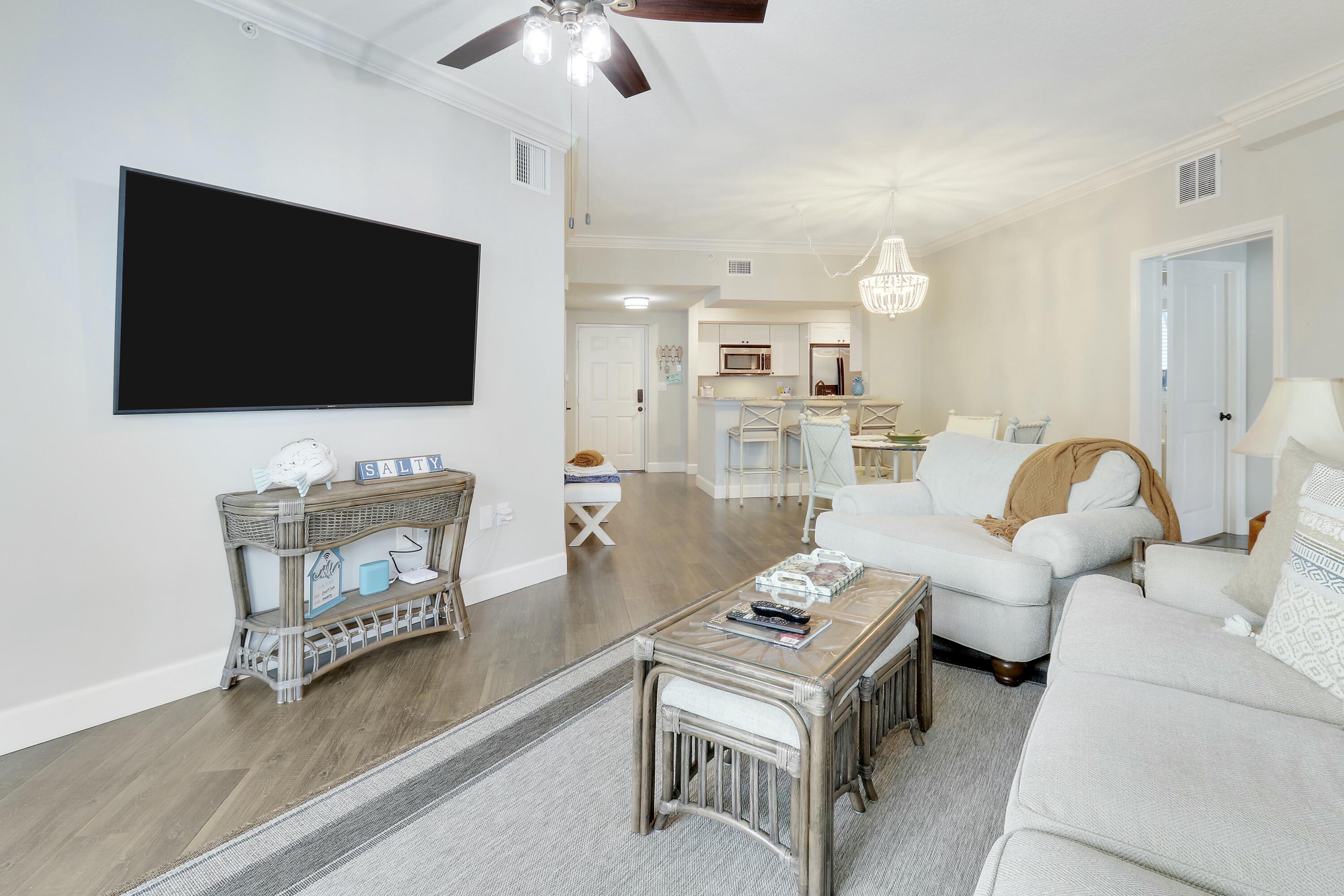 215 Northwest Flagler Avenue, Unit 301 Stuart, FL 34994 - Photo 20 of 34 a living room with furniture and a flat screen tv