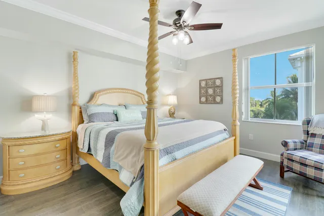 a bedroom with a bed wooden floor and window
