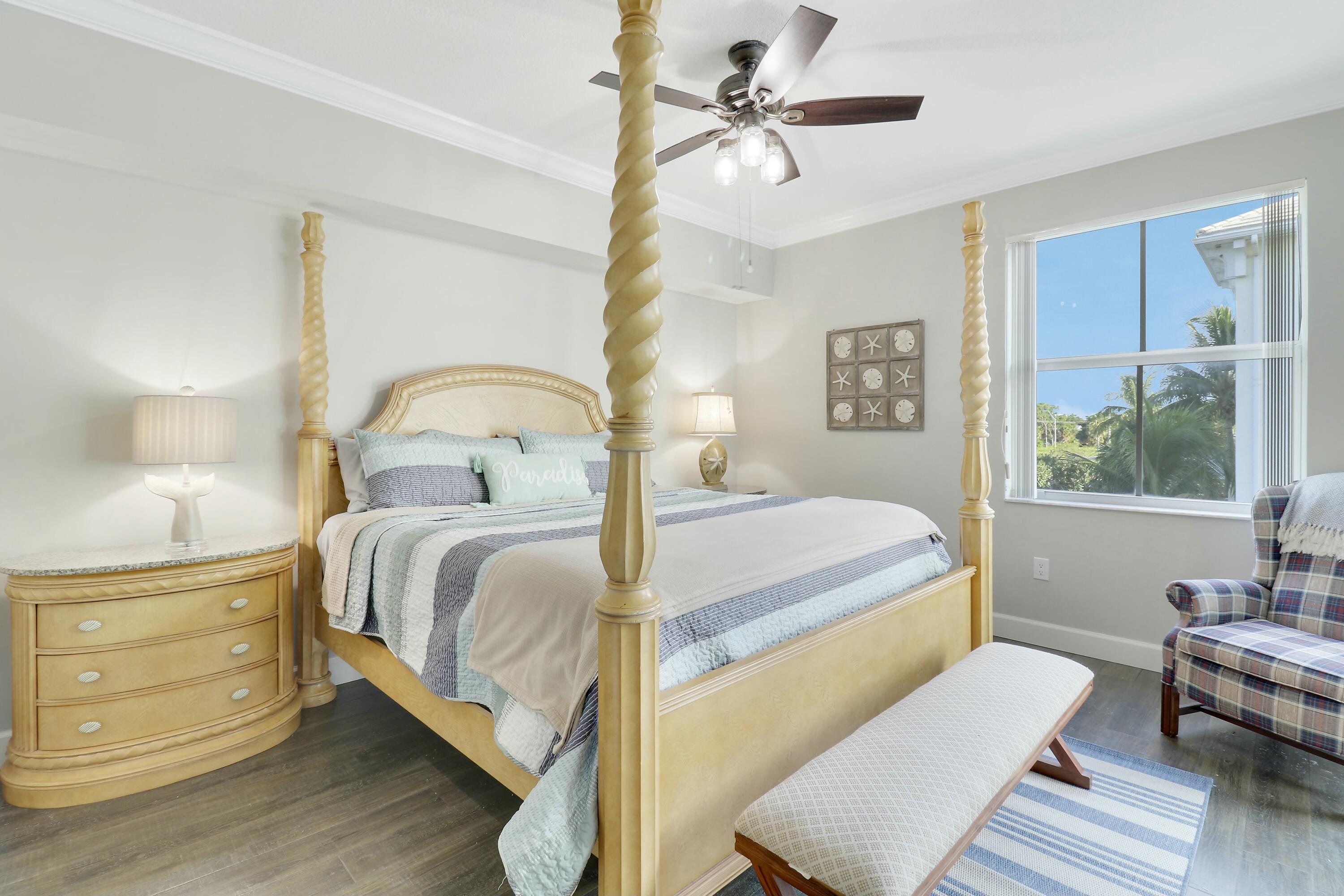 215 Northwest Flagler Avenue, Unit 301 Stuart, FL 34994 - Photo 21 of 34 a bedroom with a bed wooden floor and window