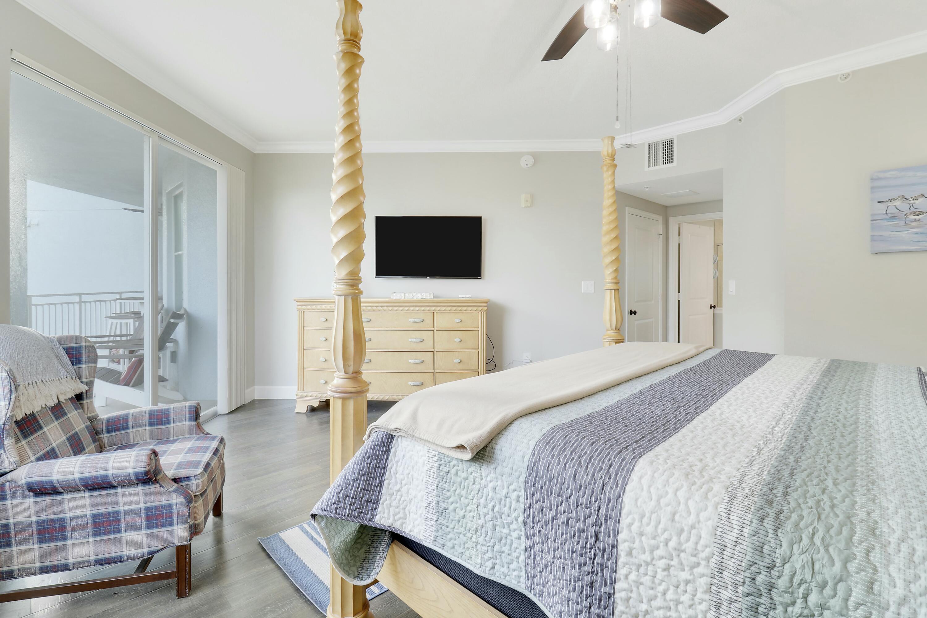 215 Northwest Flagler Avenue, Unit 301 Stuart, FL 34994 - Photo 23 of 34 a bedroom with a bed and flat screen tv